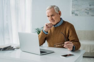 Man in front of computer making decisions