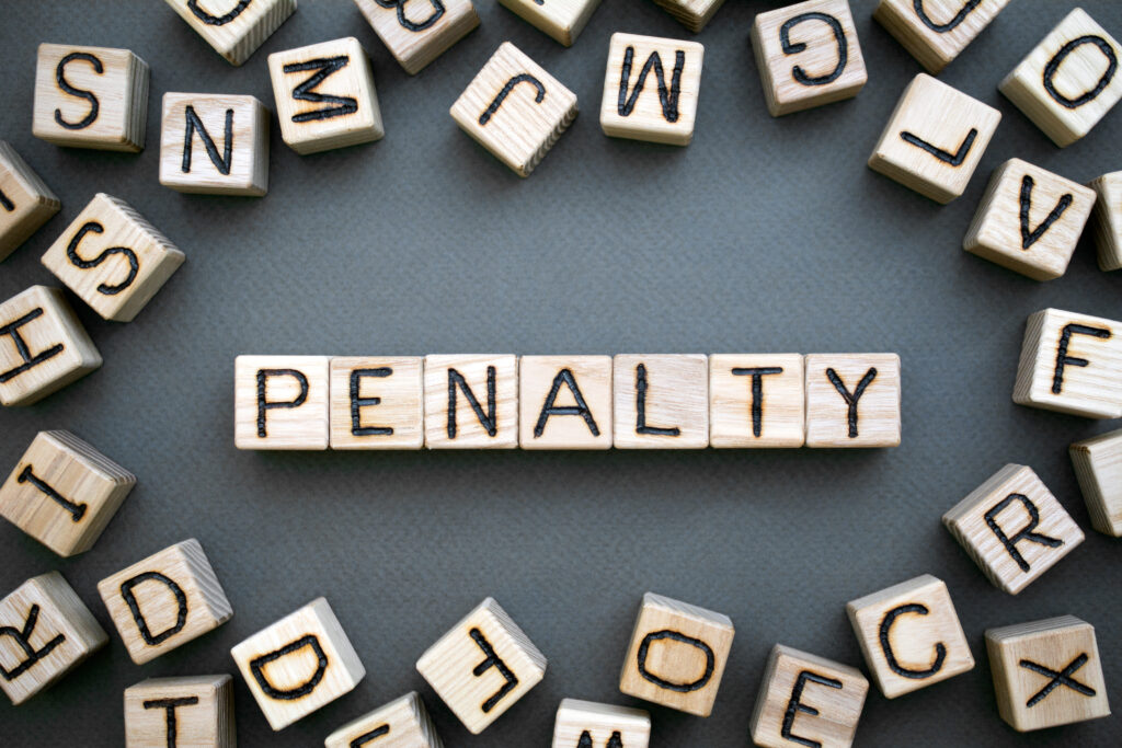 Scrabble pieces spelling out "penalty'